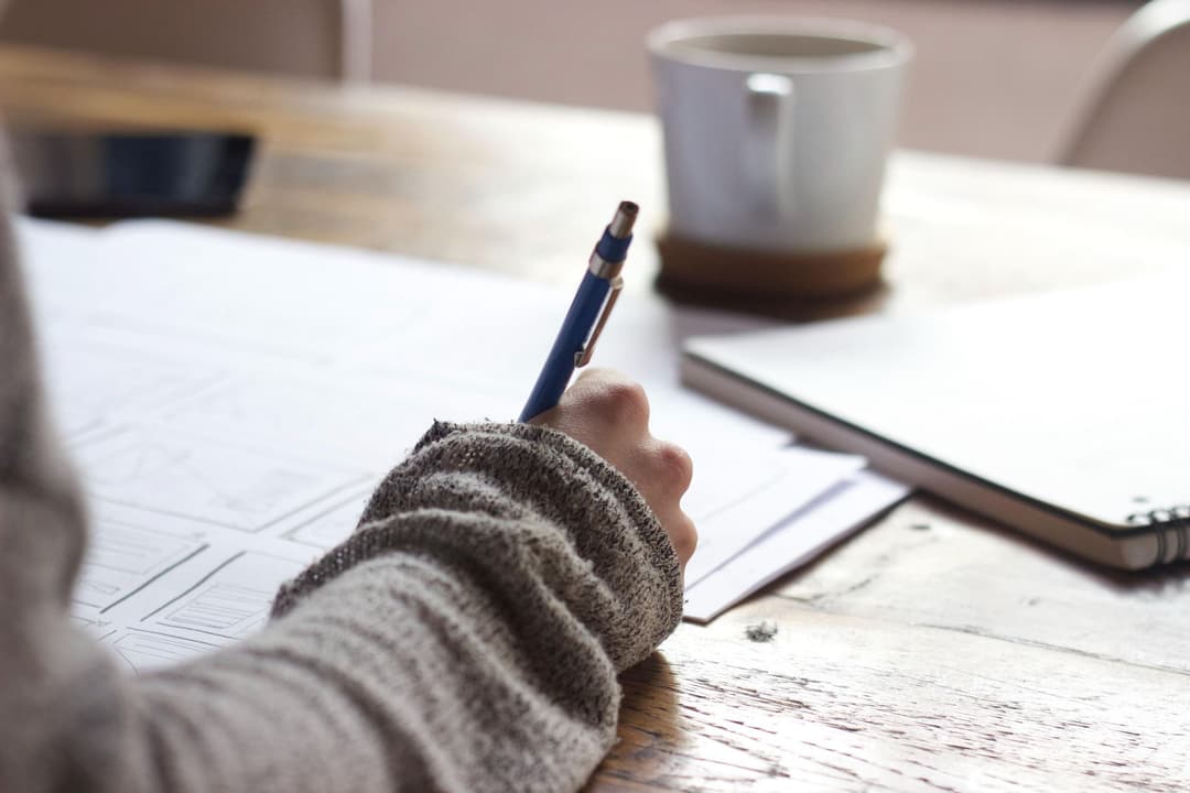 Woman filling out form with blue pen