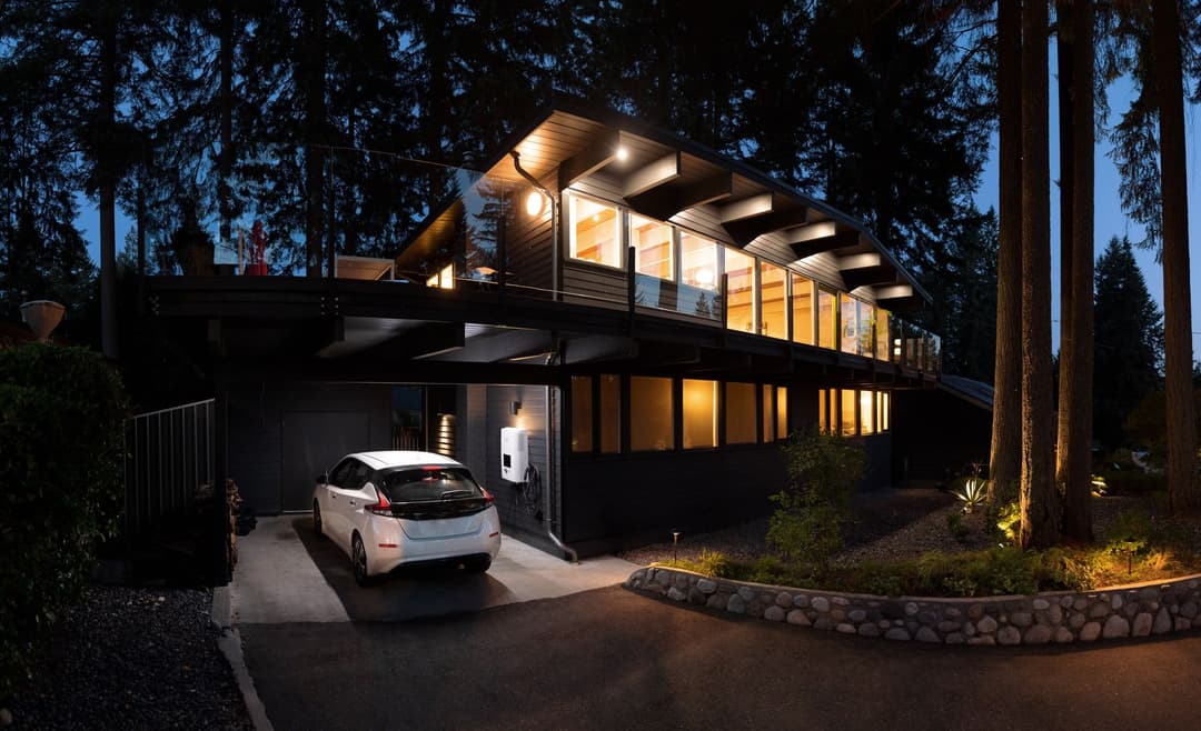 Home with EV charger and white EV charging in garage