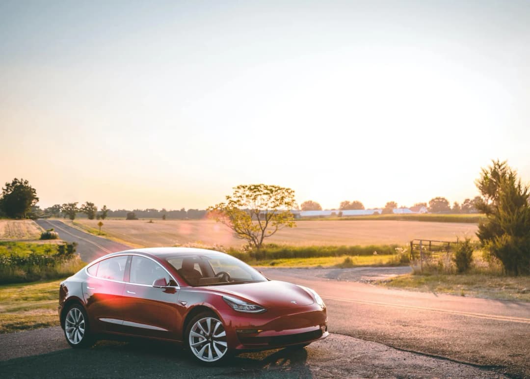 Red old Tesla on the side of the road 