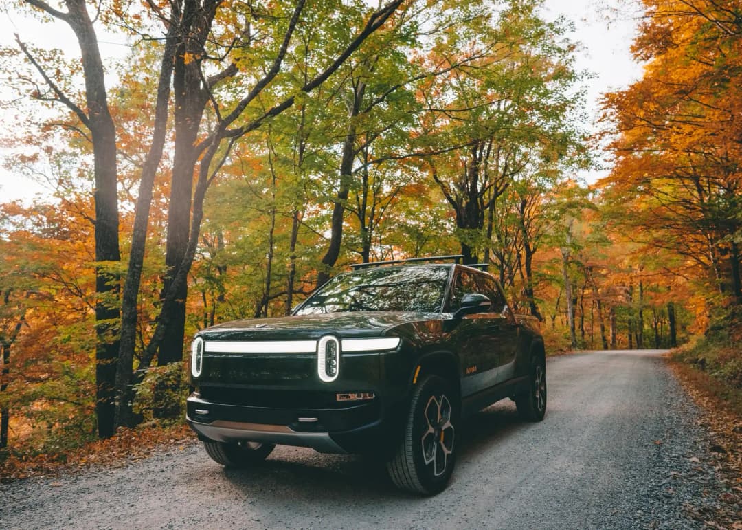 Rivian R1T truck on road in fall