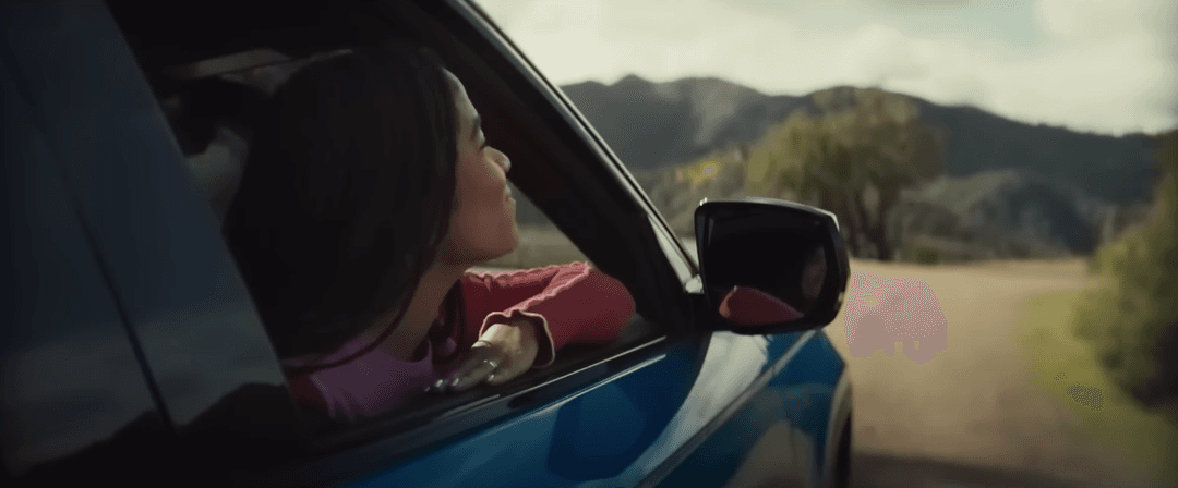 Woman looking out of Jeep electric vehicle 