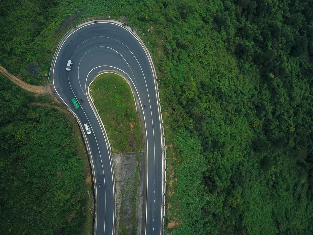 Aerial view of cars driving on a windy road 