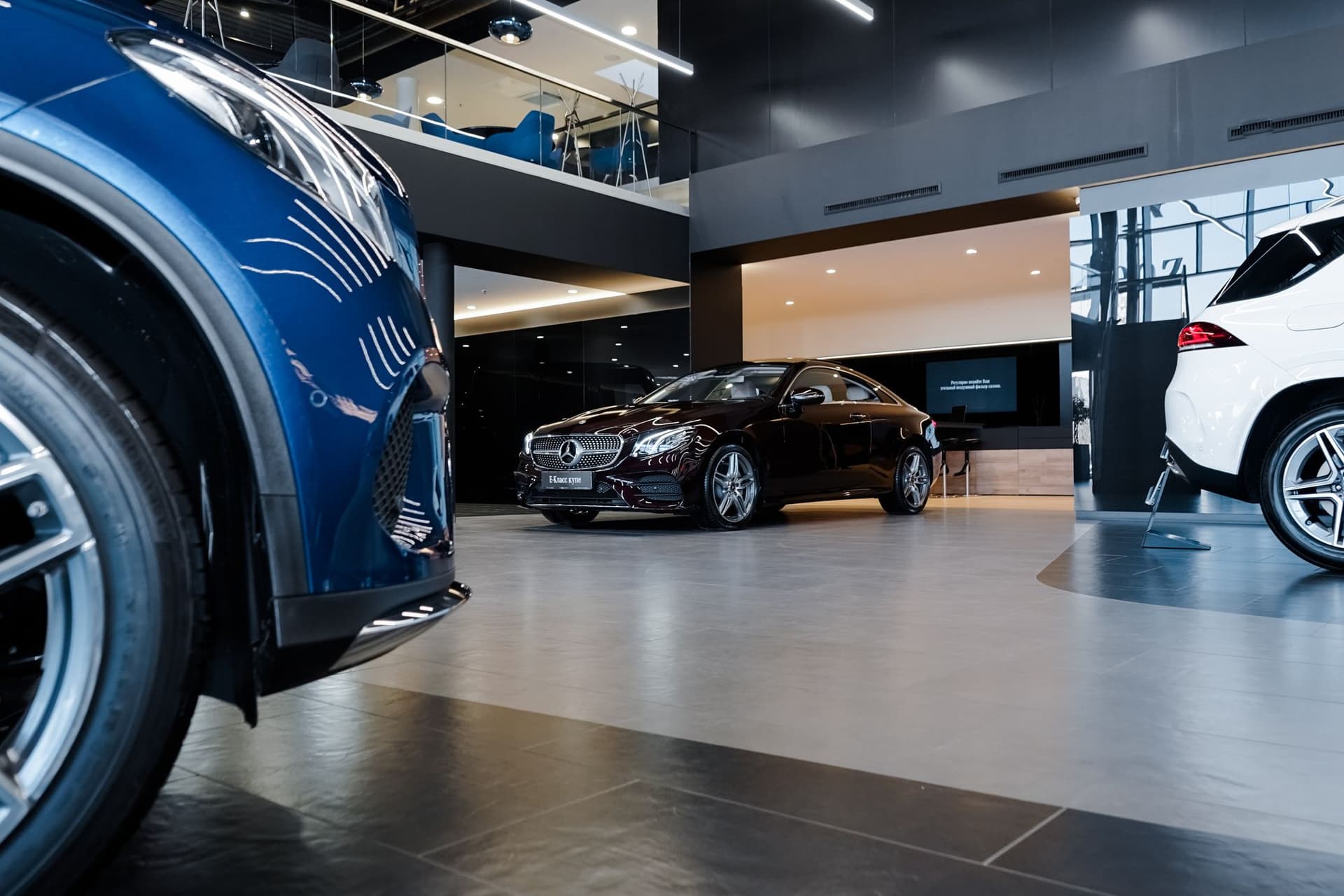 Dealership with black Mercedes and other cars around it.